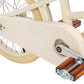 Close-up of a bicycle's kickstand and rear wheel on a white background