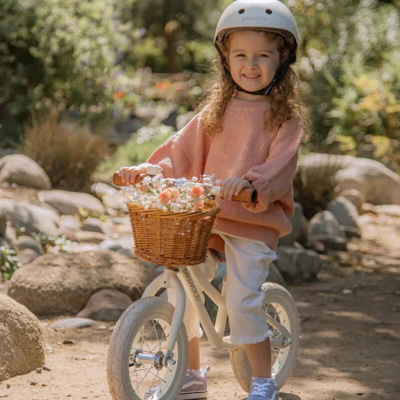 Child on a bicycle with a basket in a natural setting