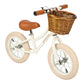 White balance bike with brown seat and basket on a white background