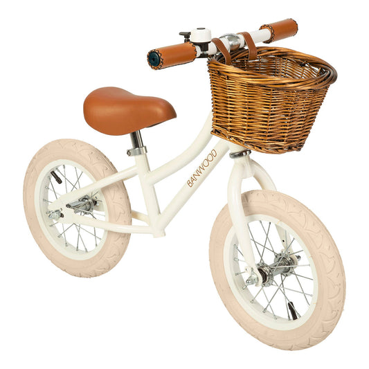 White balance bike with brown seat and basket on a white background