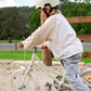Person riding a bicycle with a helmet in a park setting