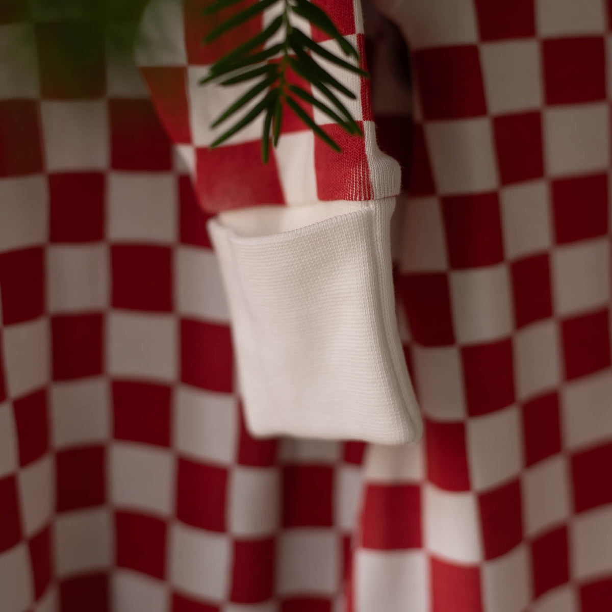 Avery Row Christmas Baby Jersey Sleepsuit - Red Checkerboard