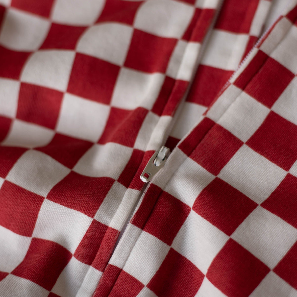 Avery Row Christmas Baby Jersey Sleepsuit - Red Checkerboard