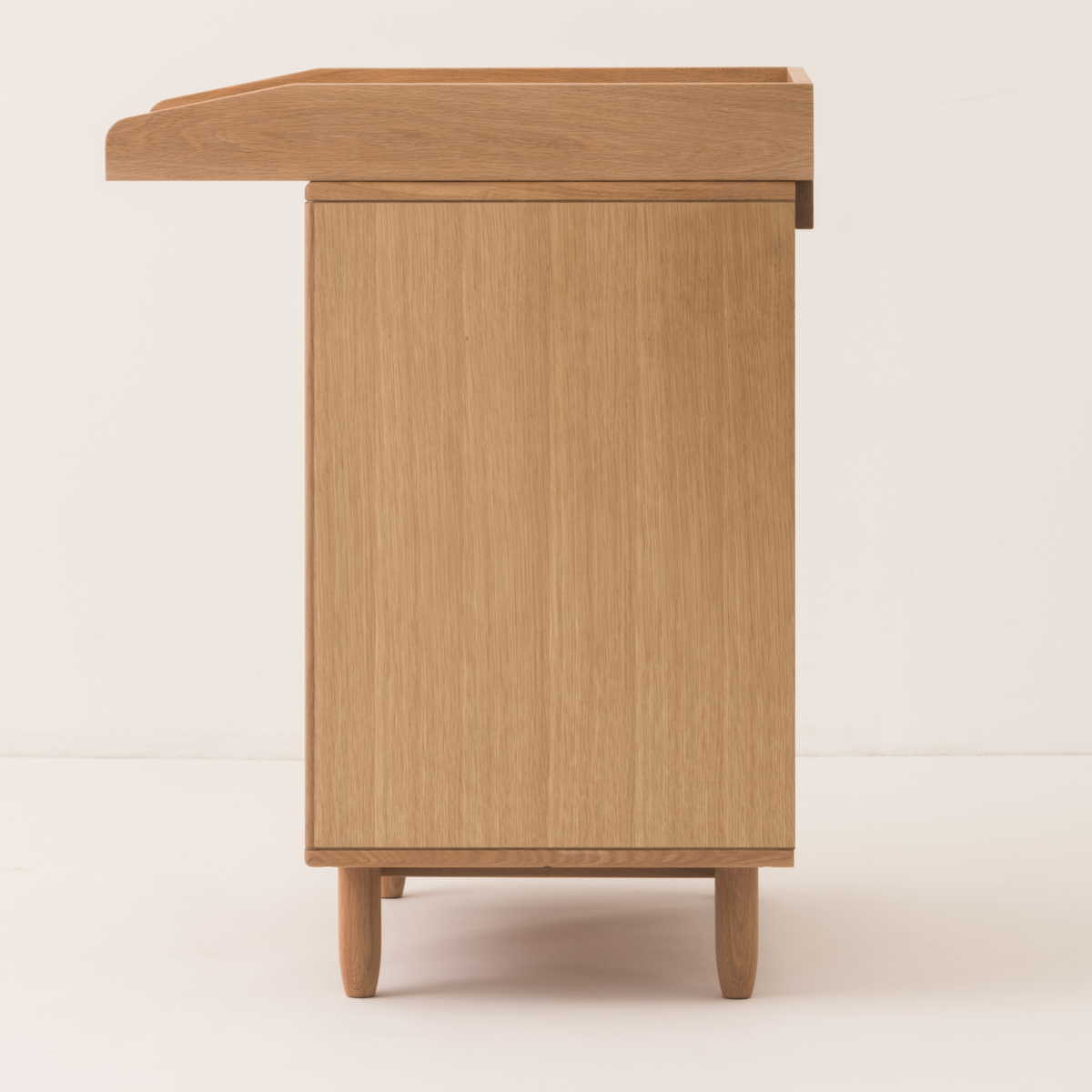 Wooden cabinet with a small shelf on a white background