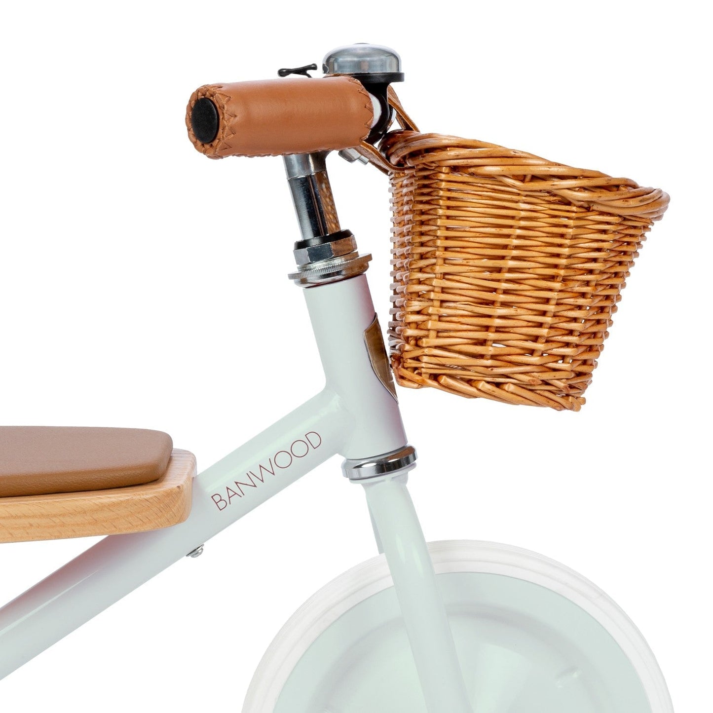 Children's balance bike with wicker basket and seat on a white background