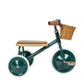 Green children's tricycle with a wooden seat and basket on a white background
