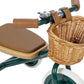Children's tricycle with brown seat and wicker basket on a white background