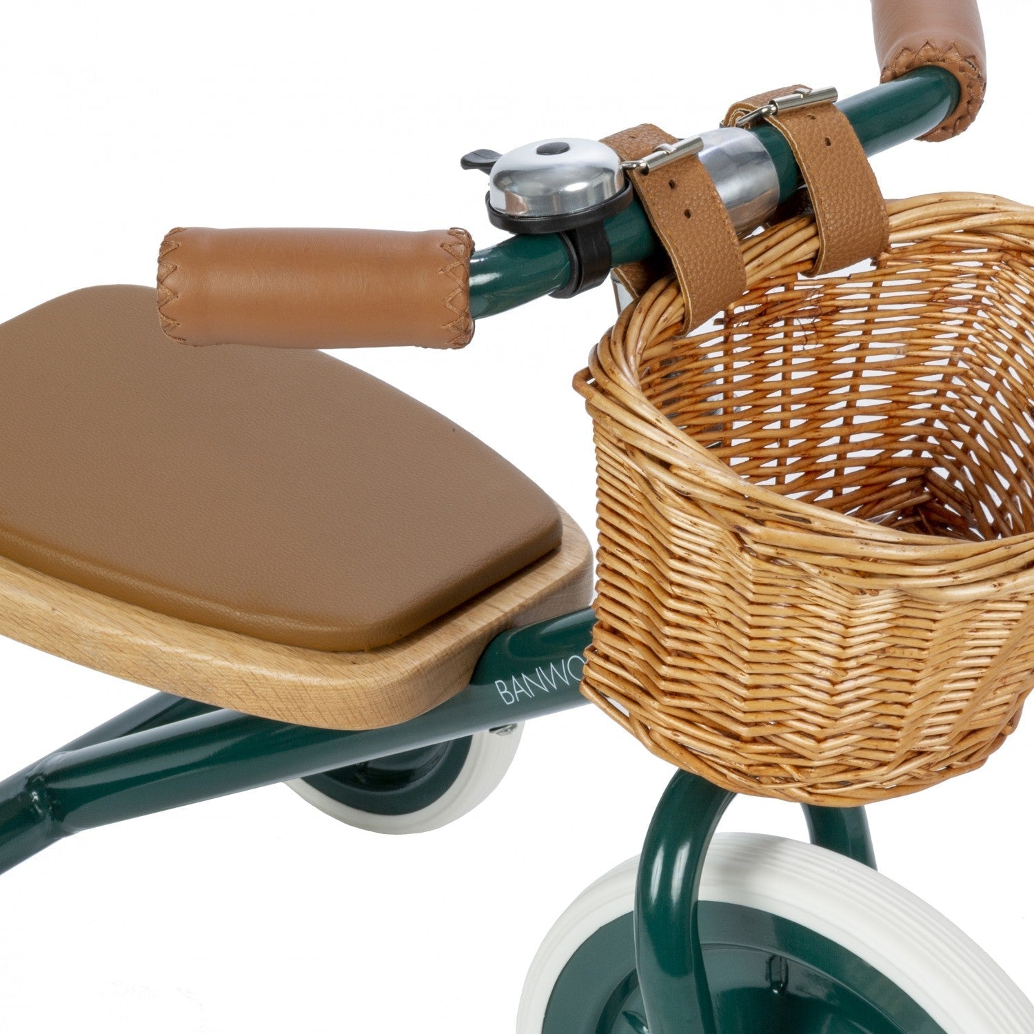 Children's tricycle with brown seat and wicker basket on a white background