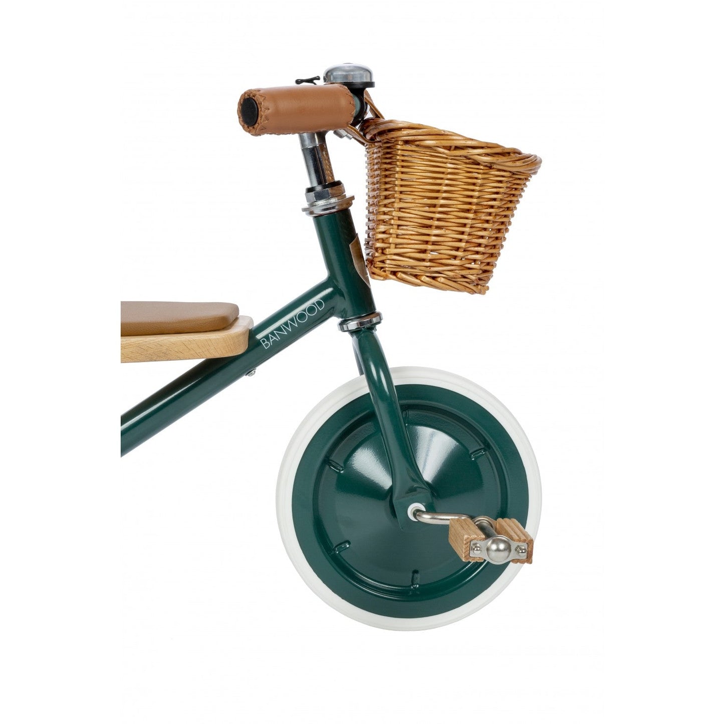 Green balance bike with a wicker basket on a white background