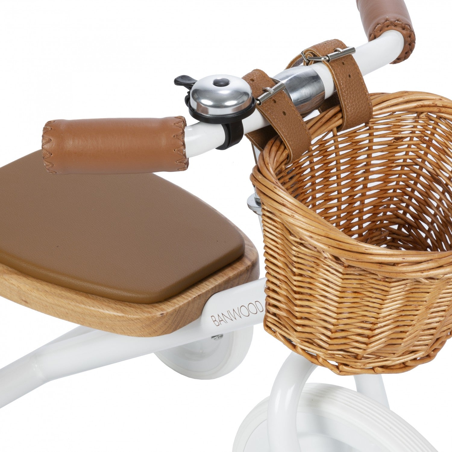 Children's tricycle with wicker basket and brown seat on a white background