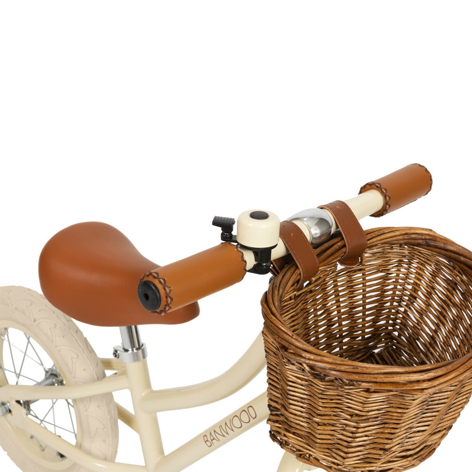 Children's tricycle with wicker basket and brown handlebar grips on a white background