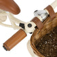 Close-up of a bicycle handlebar with brown grips and a wicker basket on a white background