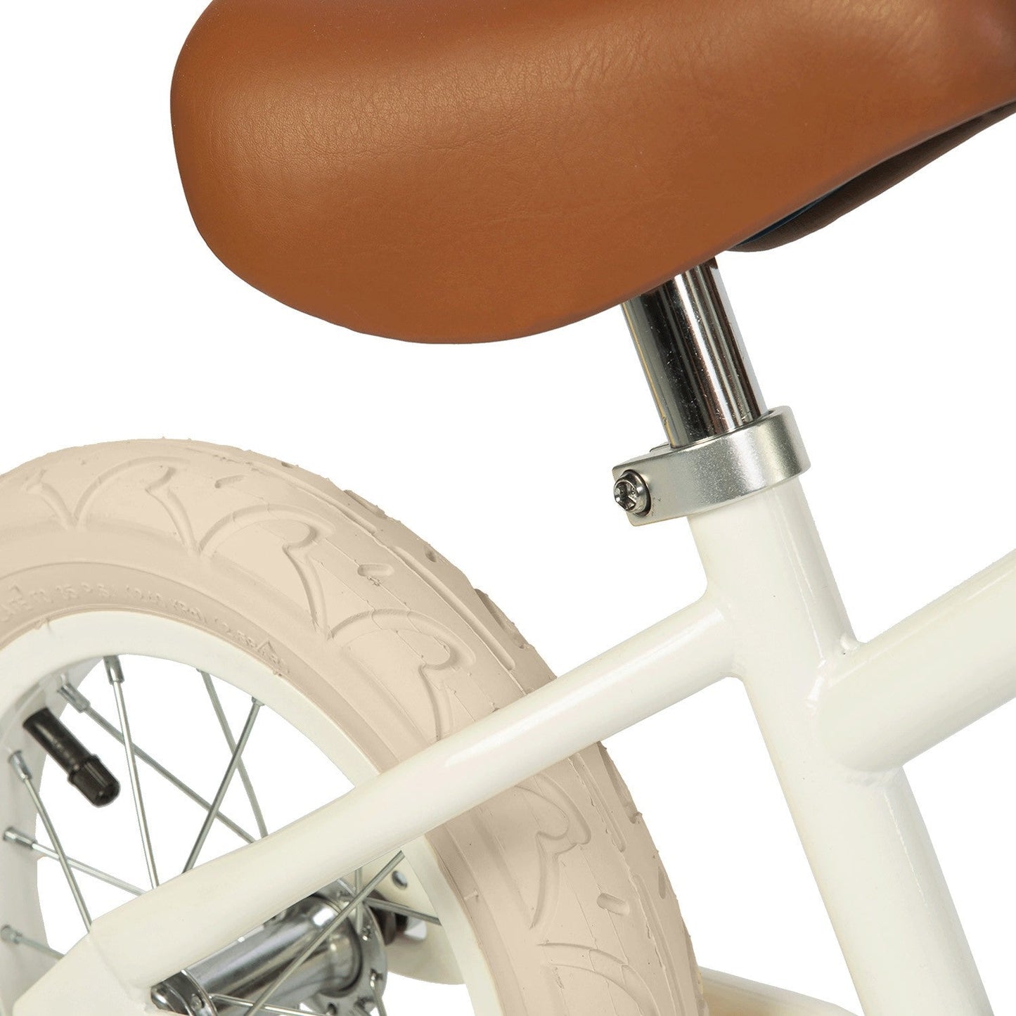 Close-up of a bicycle seat and front wheel with a white frame and brown leather seat on a white background.