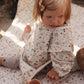 Avery Row Sleeved Baby Bib - Grasslands